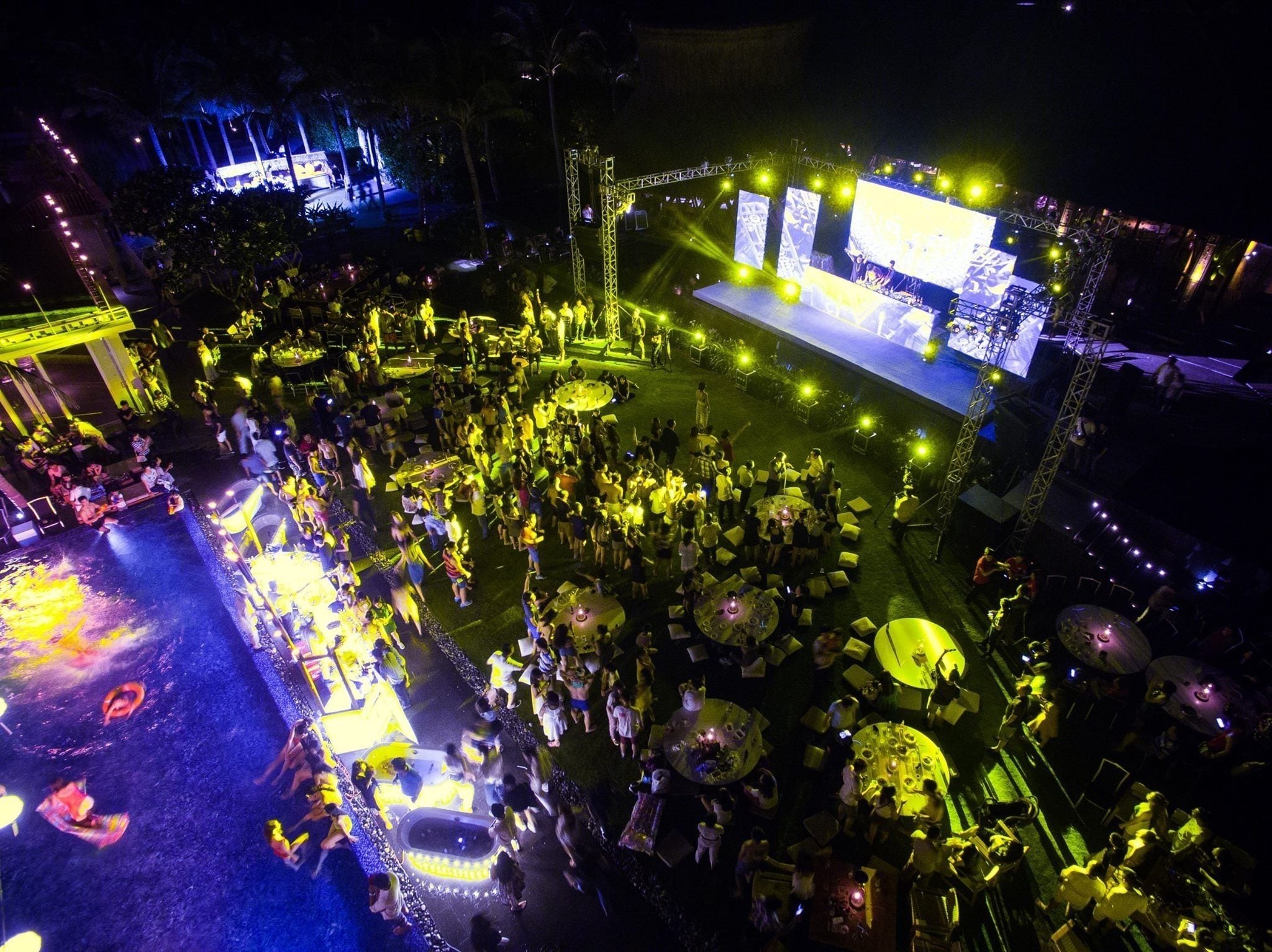 An outdoor event with a stage and audience.