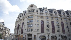 A historic building with ornate architecture, multiple balconies, and large banners advertising events. - Saint-Germain des Prés Allure, by Veeve (Paris)