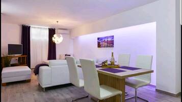Deluxe Apartment, 1 Bedroom | Living area | Flat-screen TV