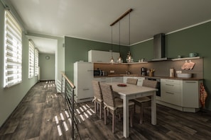 Enjoy cooking in this well-equipped kitchen with a central island, sink, and stainless steel range hood.