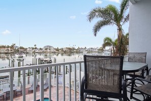 Enjoy the serene marina views from this balcony, complete with a table and chairs.