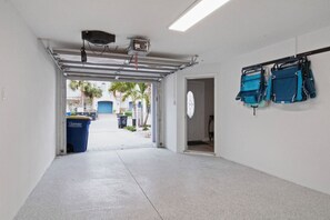 Guests can enjoy a view of palm trees and a building from the outdoor area accessible through the door.