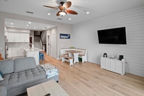 Relax in this stylish living space with a sofa, dining area, and kitchen, perfect for unwinding and enjoying quality time with loved ones.