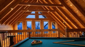 A pool table in a wooden room with a high ceiling and skylights. - ♡♡Mtn View W/easy Access, Hot Tub, WiFi,  Smart TV & 10 Minutes to Attractions♡♡ (Pigeon Forge)