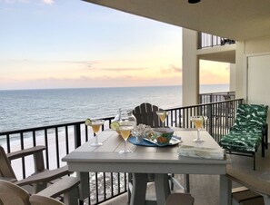 Ein Balkon mit einem Tisch für zwei Personen, mit Blick auf das Meer.