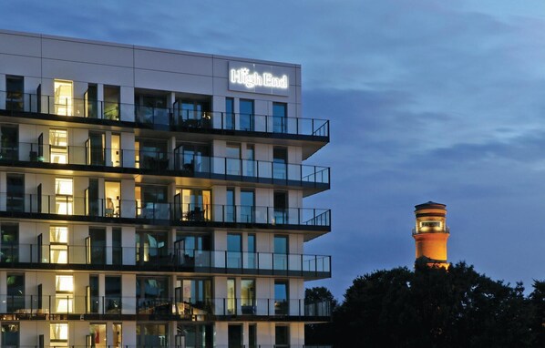 A multi-story hotel named "High End" with balconies and large windows.