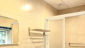 A bathroom with a sink, toilet, and shower. - Look Tea House (Meishan)