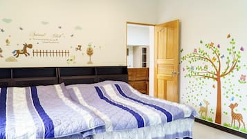 A bedroom with a bed, a wardrobe, a door, and a wall with animal-themed decorations.