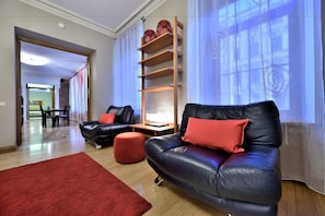 Relax in this stylish living room with a comfortable sofa, wooden side table, and large window.