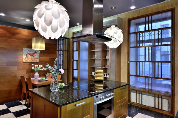 Enjoy cooking in this well-equipped kitchen with a central island, stovetop, and ample cabinetry.