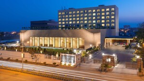 A modern hotel with a large entrance, multiple floors, and a well-lit facade. - Balaji Sarovar Premiere Solapur (Solapur)