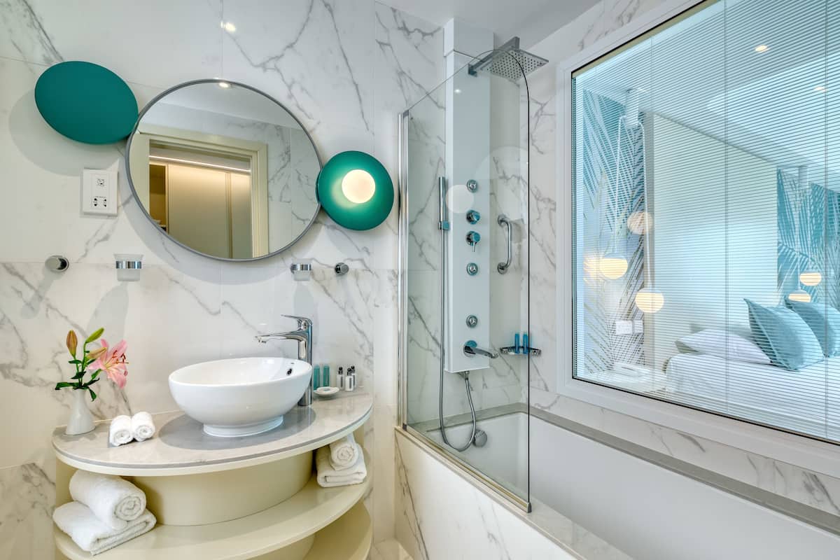 designer toiletries, hair dryer, bathrobes, slippers