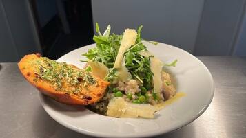 Un plato de comida con pan, vegetales verdes y arroz.