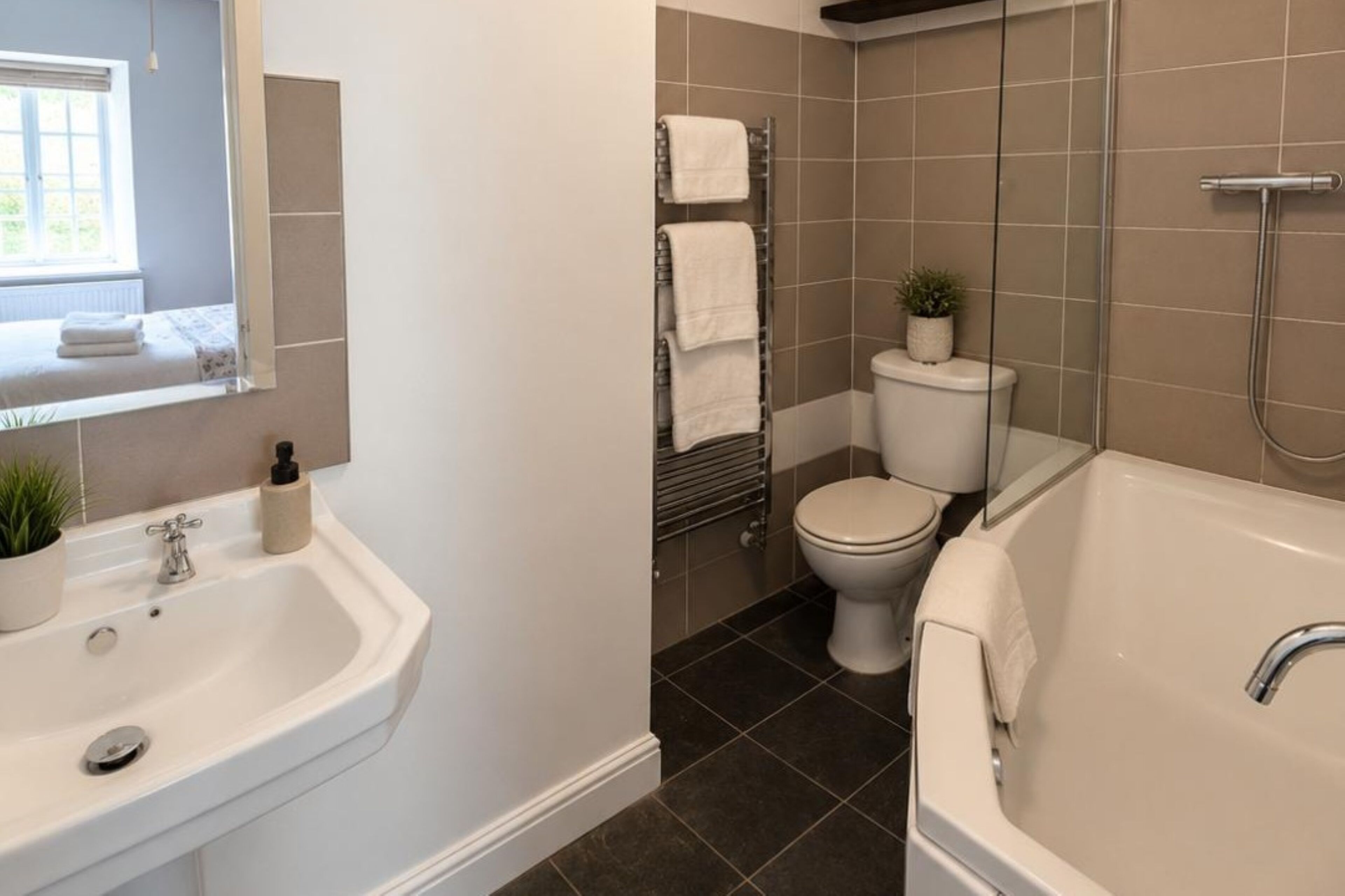 A bathroom with a sink, toilet, and bathtub.