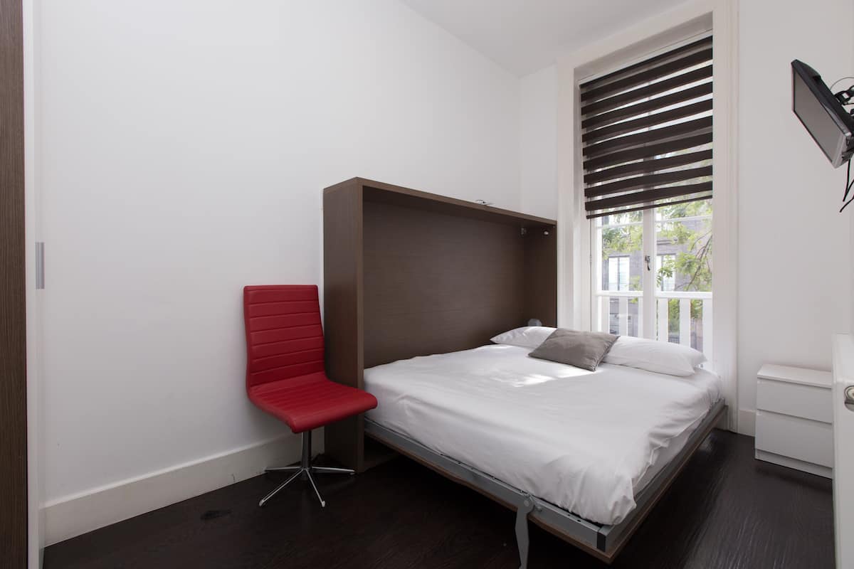 Comfort Room, 1 Double Bed, Private Bathroom | Desk, laptop workspace, blackout curtains, iron/ironing board