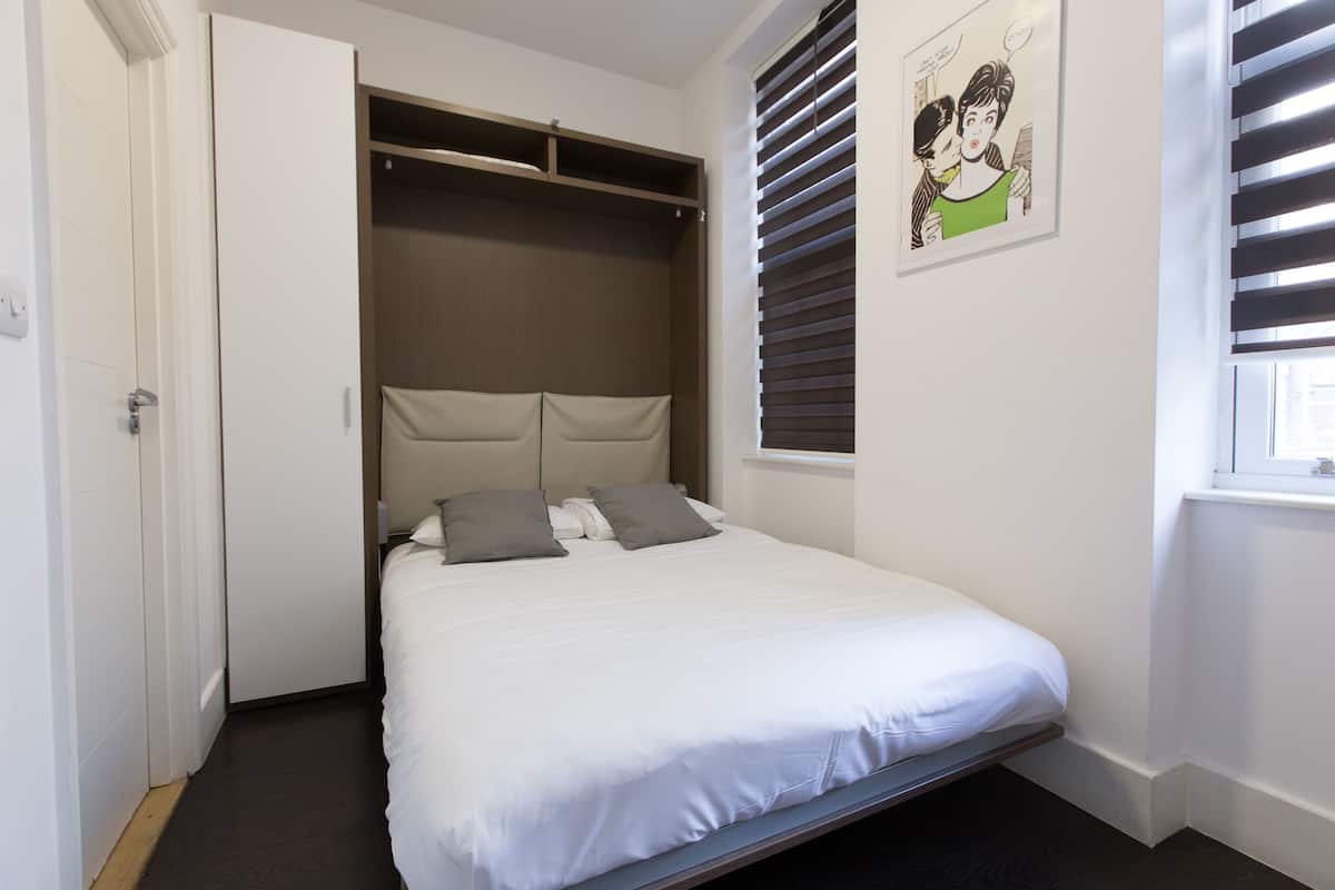 Desk, laptop workspace, blackout curtains, iron/ironing board