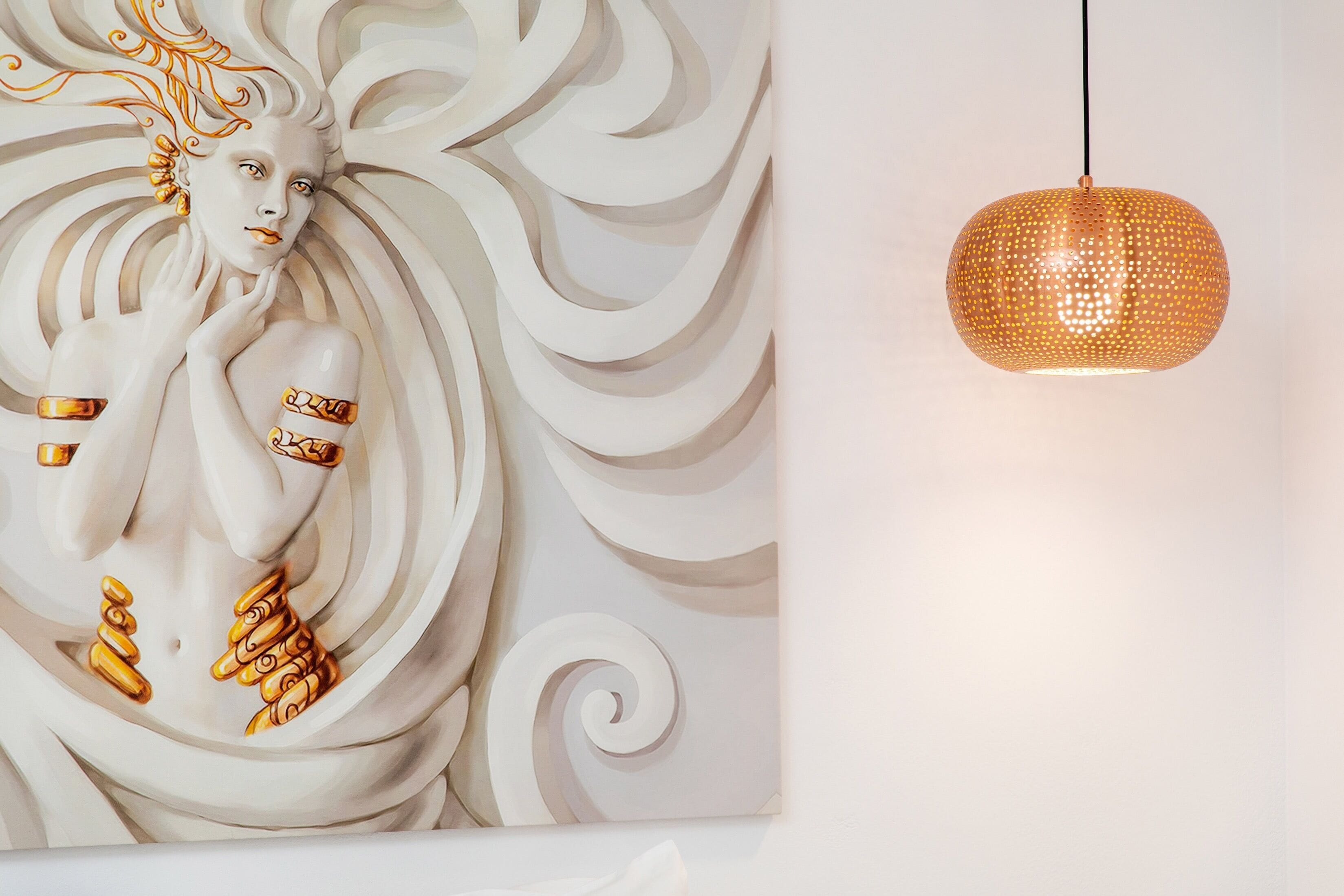 A wall with a large, abstract painting featuring swirling patterns and golden accents.
