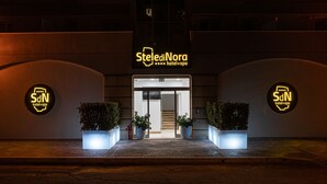 StelediNora hotel entrance with a sign, two potted plants, and a staircase leading inside. - Stele di Nora (Pula)