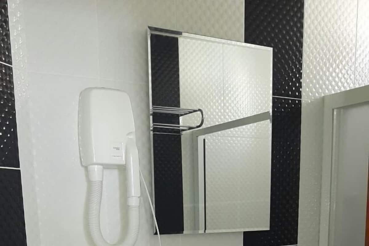 Shower, hair dryer, slippers, towels