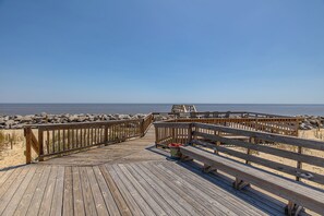 Walk along the boardwalk to the beach, where benches offer a place to sit and take in the ocean view.