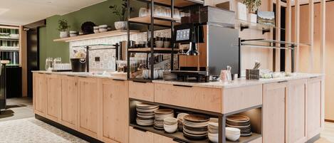 A modern kitchen with wooden cabinets, a central island, and a built-in oven.