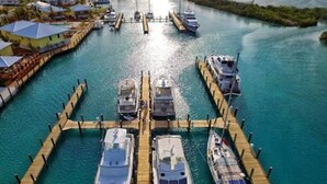 A marina with several boats docked at wooden piers. - Spanish Wells Yacht Haven (Spanish Wells)