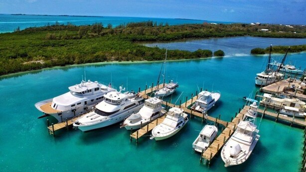 A marina with several yachts docked at wooden piers. - Spanish Wells Yacht Haven (Spanish Wells)