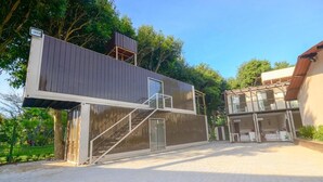 A modern two-story building with a staircase leading to the upper floor.
