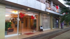 A hotel entrance with glass doors, red balloons, and an ATM on the right. - Alwaq Hotel (Bahir Dar)