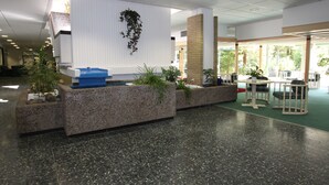 A lobby with a reception desk, seating area, and potted plants. - Ferienwohnung Riefenbach (Bad Harzburg)