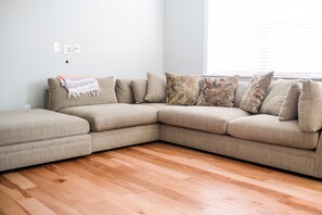 Relax in this stylish living room with a comfortable L-shaped sofa and large window.