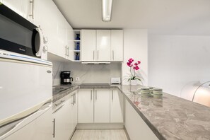 Fridge, microwave, coffee/tea maker, cookware/dishes/utensils