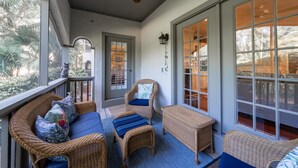 A covered porch with wicker furniture, a ceiling fan, and large windows offering views of the outdoors. - 3 BR/2.5 BA Family Friendly Villa! Golf Views! Amenities included! (Seabrook Island)