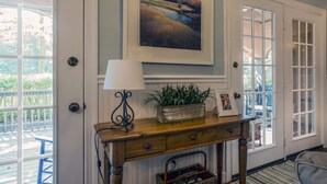 A room with a wooden console table, a lamp, a framed painting, and a sign reading "SEABROOK ISLAND". - 3 BR/2.5 BA Family Friendly Villa! Golf Views! Amenities included! (Seabrook Island)