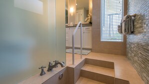 A bathroom with a glass shower enclosure, a bathtub, a toilet, and a sink. - Designer Two Bedroom | Directly Beachfront | AC | Gourmet Kitchen | Private (Waialua)