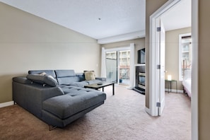 Condo | Living area | Flat-screen TV, fireplace - Suite Digs Bella Vista (Calgary)