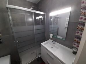 Studio, vue partielle sur la mer | Salle de bain | Douche, articles de toilette (gratuits), séchoir à cheveux, pantoufles