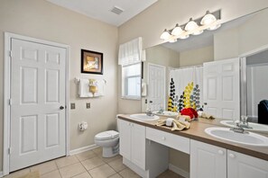 A bathroom with two sinks, a toilet, and a large mirror. There are towels and toiletries on the counter. - 7BR Pool Home Emerald Island by SHV-8409 (Kissimmee)