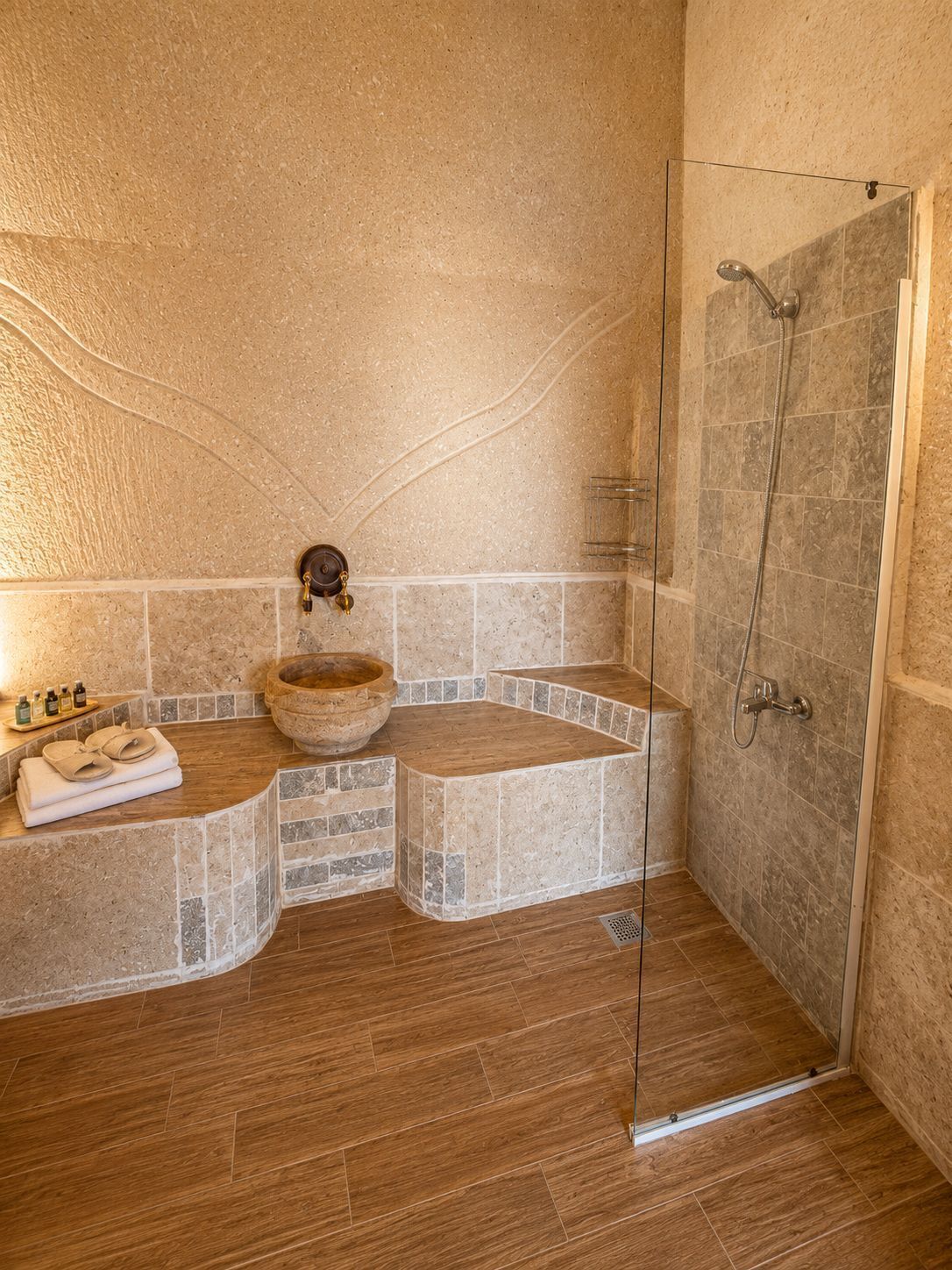 A bathroom with a stone sink, a shower, and a wooden bath mat.