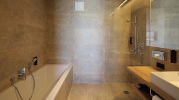 Un baño moderno con bañera, ducha y tocador.