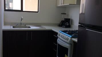 Departamento Deluxe, 2 habitaciones | Cocina privada | Refrigerador, horno, parrilla de estufa y cafetera y tetera