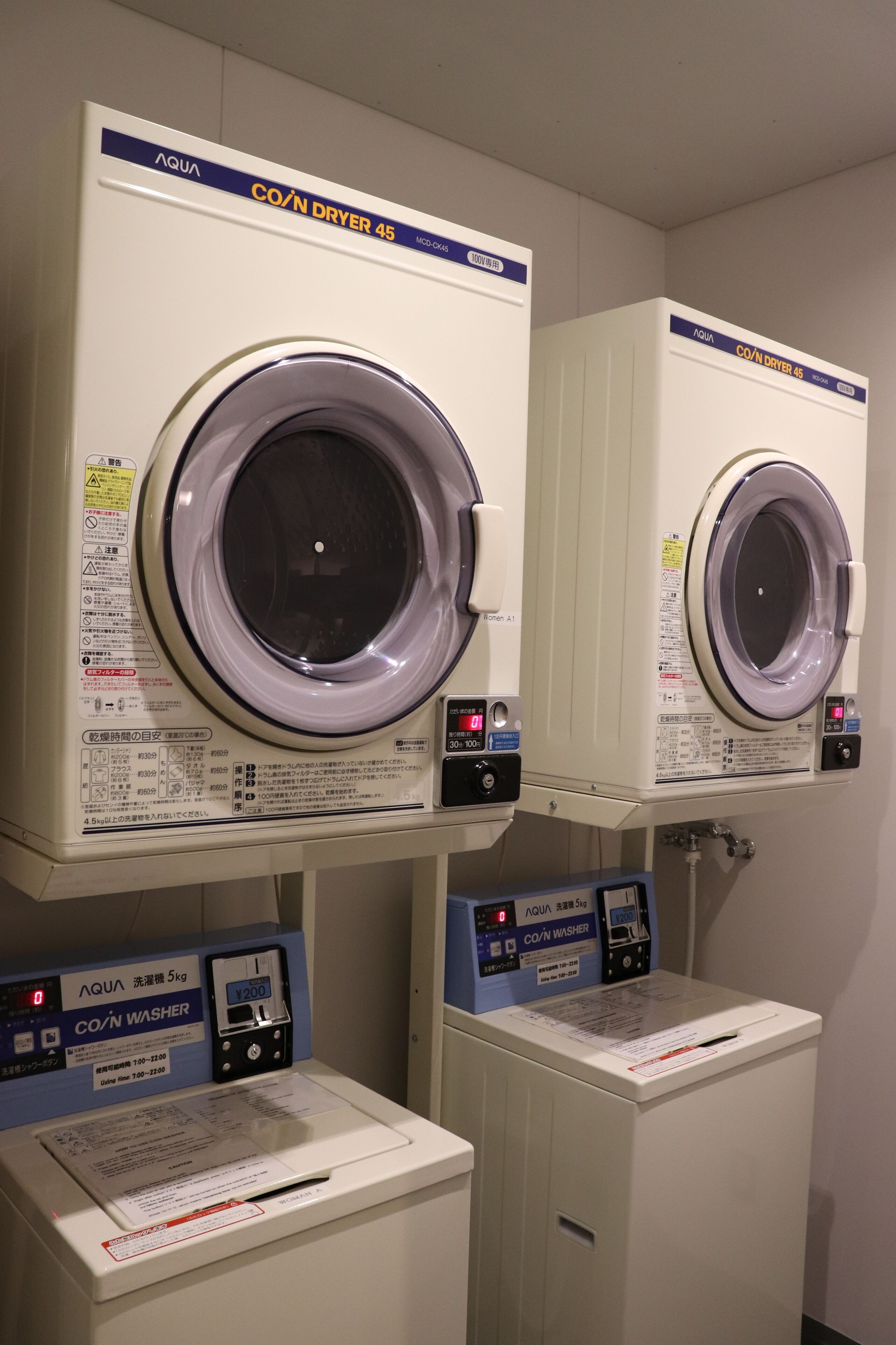 Two AQUA CO/N DRYER 45 machines with control panels, located in a utility room.