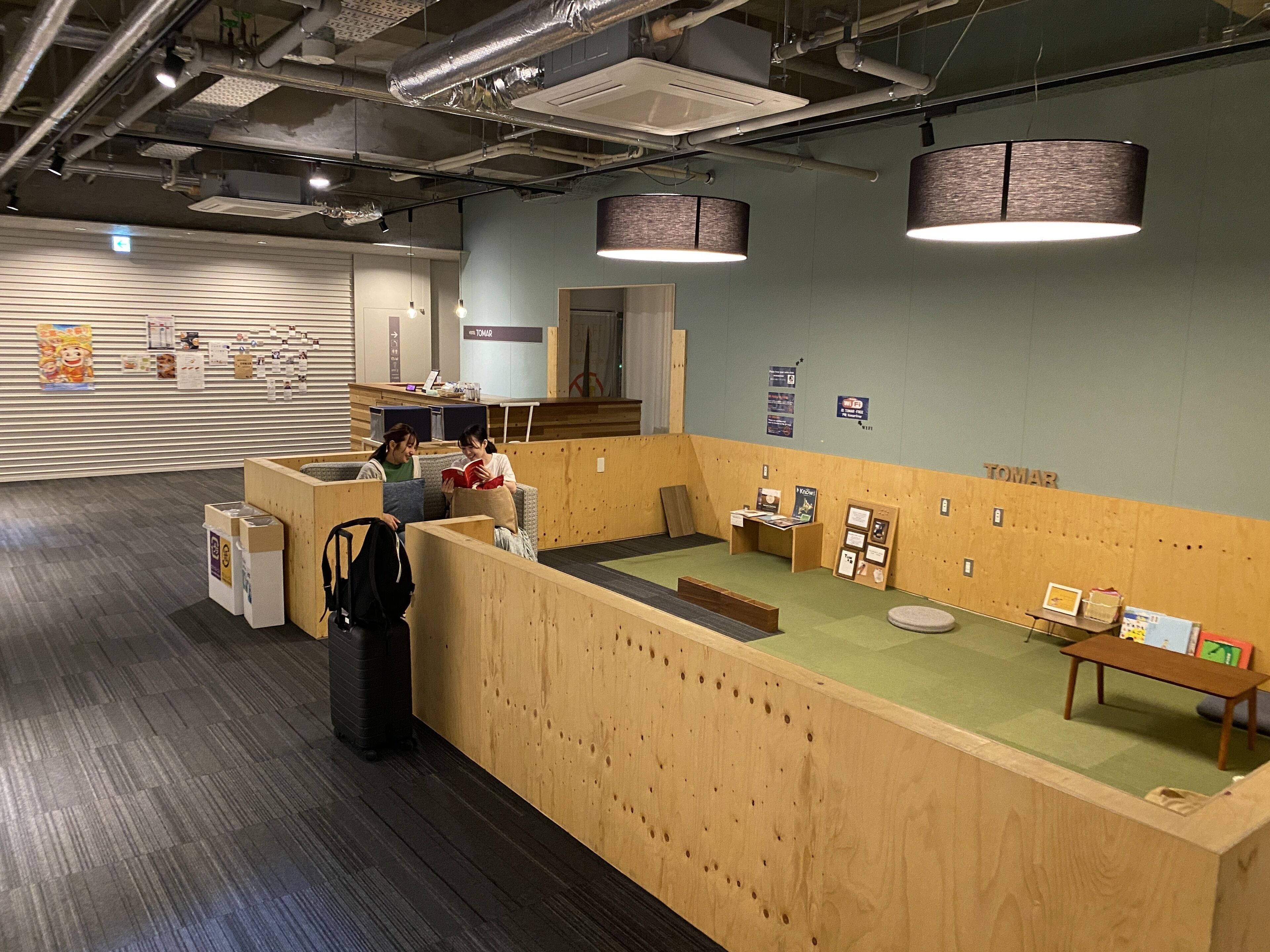 A reception area with a wooden counter, a seating area, and a display of informational materials.