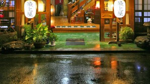 A traditional Japanese building with a sign indicating it is a hotel. - Mogamiya Ryokan (Shiroishi)