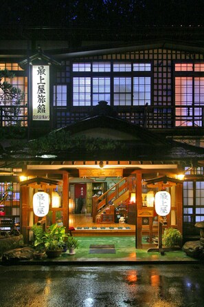 A traditional Japanese building with a sign indicating it is a hotel. - Mogamiya Ryokan (Shiroishi)