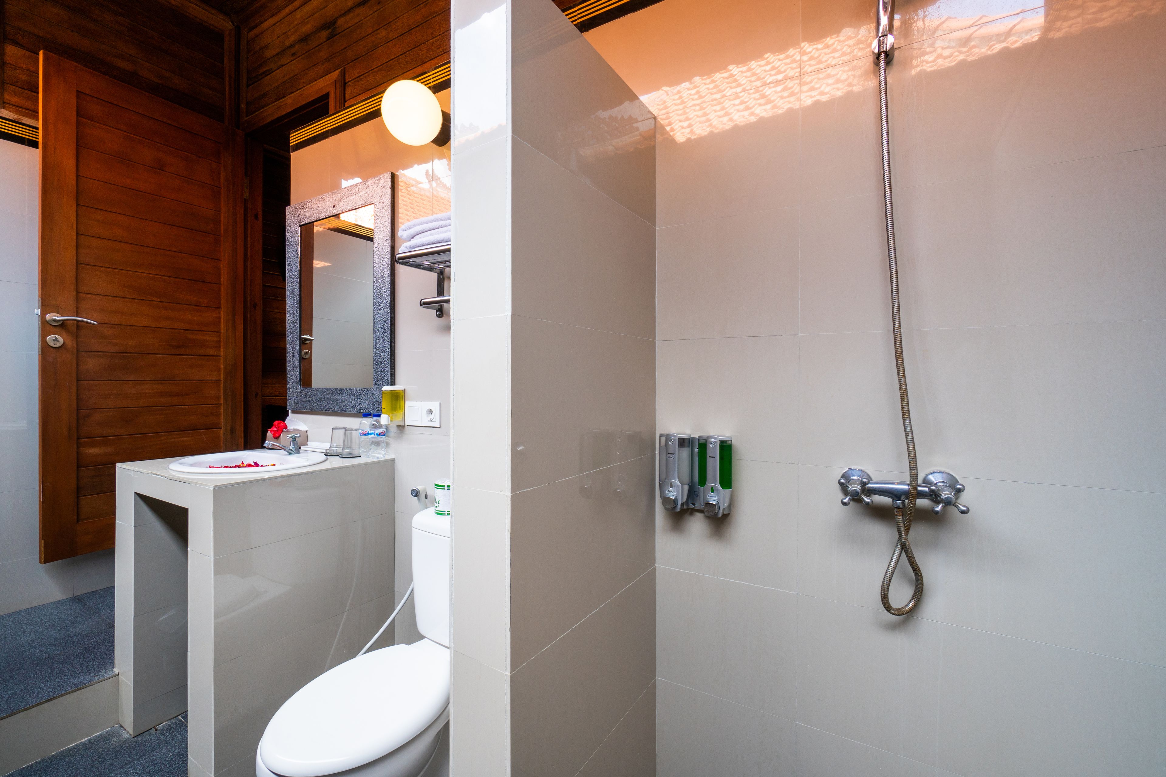 A bathroom with a toilet, sink, and shower.