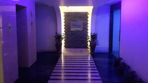 A hallway with a sign reading "Options Lounge" leading to a room. - Castle Inn (Khandwa)