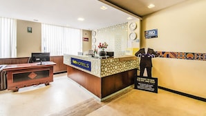 A hotel reception desk with a sign reading "fabHOTELS" and a "NO TRESPASSING" sign. - FabHotel Oriental Suites MG Road (Bengaluru)