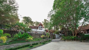 A traditional house with a stone wall and a staircase leading to the entrance. - Krabi Villa Phu Khao Private Resort (Krabi)