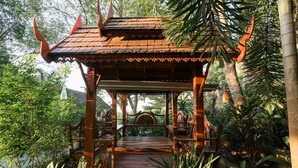 A traditional wooden pavilion with a tiled roof, surrounded by lush greenery and plants. - Krabi Villa Phu Khao Private Resort (Krabi)
